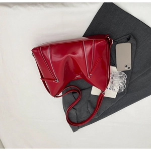Detailed top view of bright red faux leather tote bag with unique quadruple zipper accents