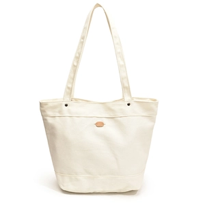 Minimalist cream canvas tote bag with brown leather patch and reinforced straps for daily use
