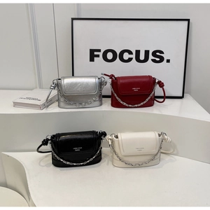 Detailed display of modern bucket bags in silver, red, black, and beige with chain details
