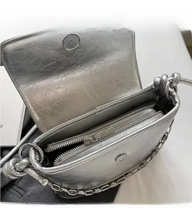Detailed interior of silver bucket bag showing smooth zipper and magnetic closure