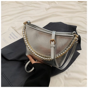Detailed view of silver shoulder bag with metallic crinkle texture and chain handle