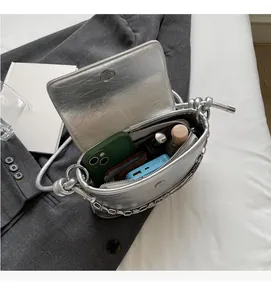 Silver metallic bucket bag showing spacious interior with zipper pocket and essentials