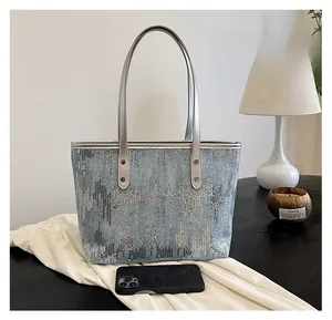 Sequin tote bag size comparison with a smartphone showing its medium capacity