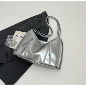 Close-up of metallic silver tote bag with vertical zipper and soft leather texture