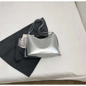 Metallic silver crossbody bag with adjustable strap and sleek mirror finish detail