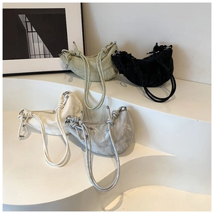 Detailed display of crescent bags in mint, black, white, and silver with knotted straps