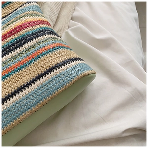 Detail shot of colorful woven texture and stitching on the base of the tote bag