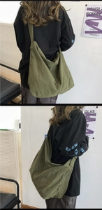 Close-up of olive green canvas hobo bag showing high capacity and durable fabric texture