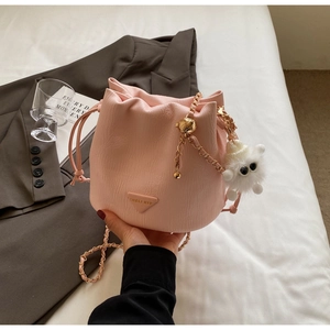 Detail of pink bucket bag with pleated leather, drawstring and gold chain strap