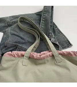 Detail of olive green canvas tote with pink drawstring and comfortable wide shoulder strap