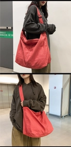 Macro shot of a red large capacity canvas hobo bag with adjustable wide shoulder strap