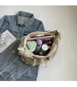 Interior view showing large capacity of the beige pleated tote with daily essentials