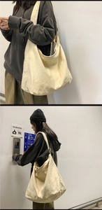 Detail of the durable cream canvas tote bag showing its large capacity and thick strap