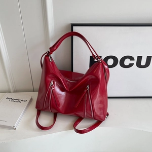 Fashionable red high-gloss bow tote bag with metallic zipper and spacious interior