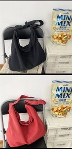Detailed comparison of black and red canvas crossbody bags with adjustable straps