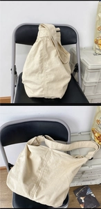 Detail of spacious beige canvas hobo bag showing texture and wide strap for daily use