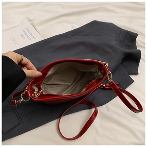 Top view of red handbag showing light gray fabric lining and spacious interior