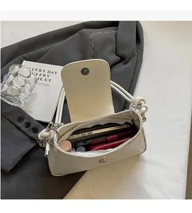 Interior view of white crocodile pattern handbag showing space for phone and wallet