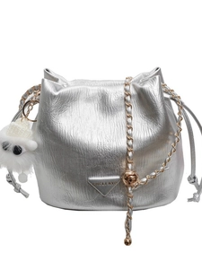 Silver metallic chain bucket bag with wrinkled texture and plush pendant accessory