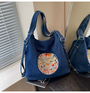 Close-up of intricate dragon embroidery on a premium large-capacity denim tote bag