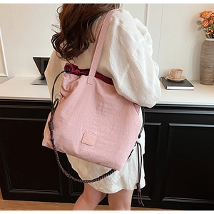 Close-up of light pink canvas tote bag showing soft texture and premium drawstring details