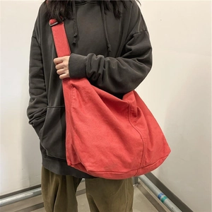 Minimalist large red canvas crossbody bag with wide strap for students and daily commute
