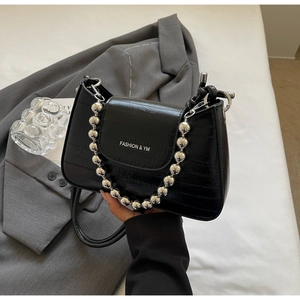 Detail of black faux crocodile skin handbag with silver bead handle and FASHION & YM text