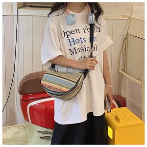 Colorful striped straw half-moon bag with adjustable black strap for summer beach vacations
