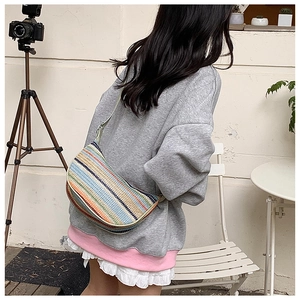 Detail of colorful striped woven crossbody bag with vibrant handmade crochet texture