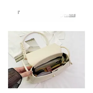 Detail view of cream crossbody bag interior showing large capacity and multi-compartment storage