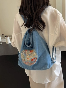 Blue denim backpack tote with colorful dragon embroidery and large storage capacity