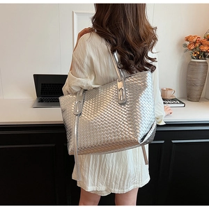 Close-up of metallic silver woven tote bag texture with minimalist modern styling