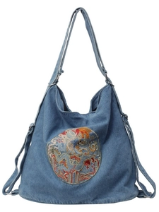 Blue denim hobo bag featuring ethnic dragon embroidery and adjustable shoulder strap