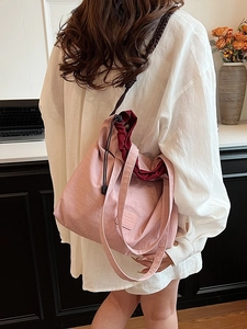 Pink quilted nylon drawstring tote bag with a woven shoulder strap for daily commuting
