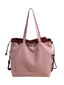 Lightweight pink large capacity tote bag with drawstring closure for daily commuting