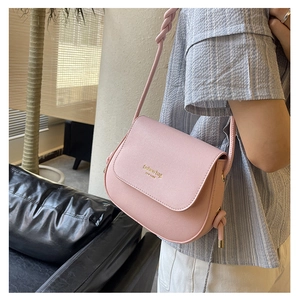 Pink PU leather crossbody bag featuring twist knot strap and New York logo detail