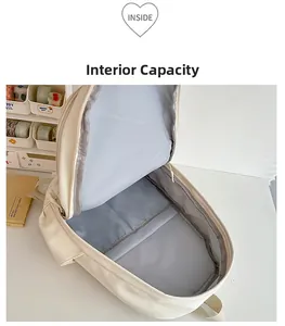 Top view of beige backpack open interior showing spacious laptop compartment and grey lining