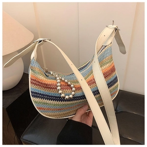 Close-up of rainbow striped straw dumpling bag with beaded chain and leather strap