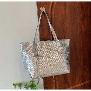 Detail of silver woven tote bag featuring high-capacity design and metallic PU leather finish