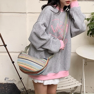 Colorful striped straw shoulder bag in a crescent shape for summer beach fashion wear