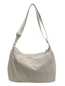 Minimalist beige nylon crossbody bag with adjustable strap and front snap pocket