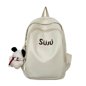 Cream canvas student backpack with SUJU print and plush dog charm on white background