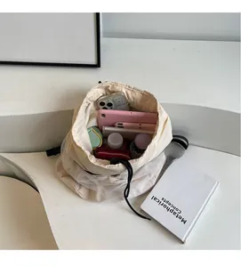 Interior view showing the large storage capacity of this cream drawstring bucket bag