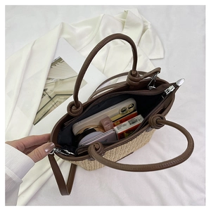 Top view of beige straw tote bag showing large capacity, zipper closure and leather strap