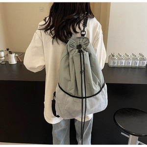 Detail showing grey-blue nylon and breathable mesh patchwork on drawstring backpack