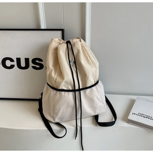 Detail of drawstring backpack with beige canvas and white honeycomb mesh panels