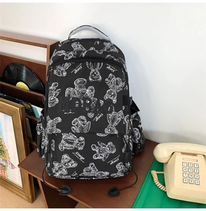 Detail eines schwarzen Rucksacks mit weißem Bärenmuster im Vintage-Design