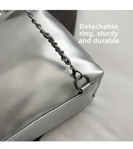 Close-up of durable detachable metal clasp and silver PU leather bag texture