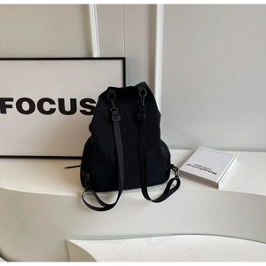 Rear view of black nylon backpack showing adjustable straps and durable fabric texture