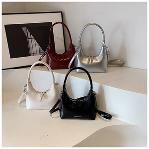 Detailed view of fashionable hobo bags in deep red, silver, cream white, and black colors